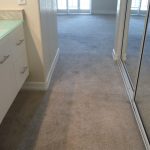 Gray berber loose and buckled carpet in vanity and into bedroom after stretching